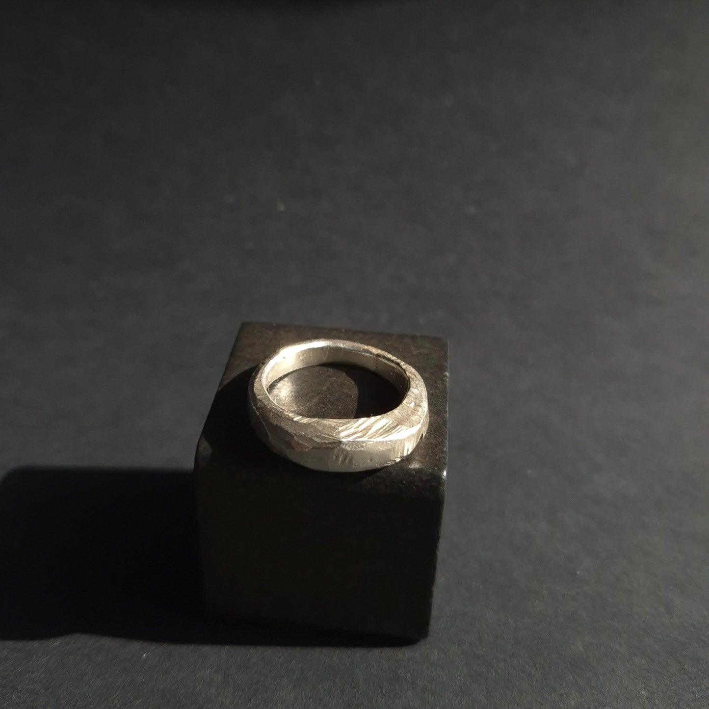 Silver ring on black background